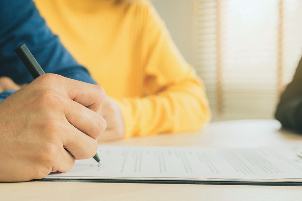 couple signing documents