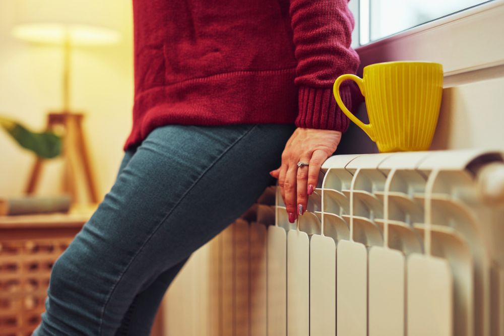 woman getting warm on radiator